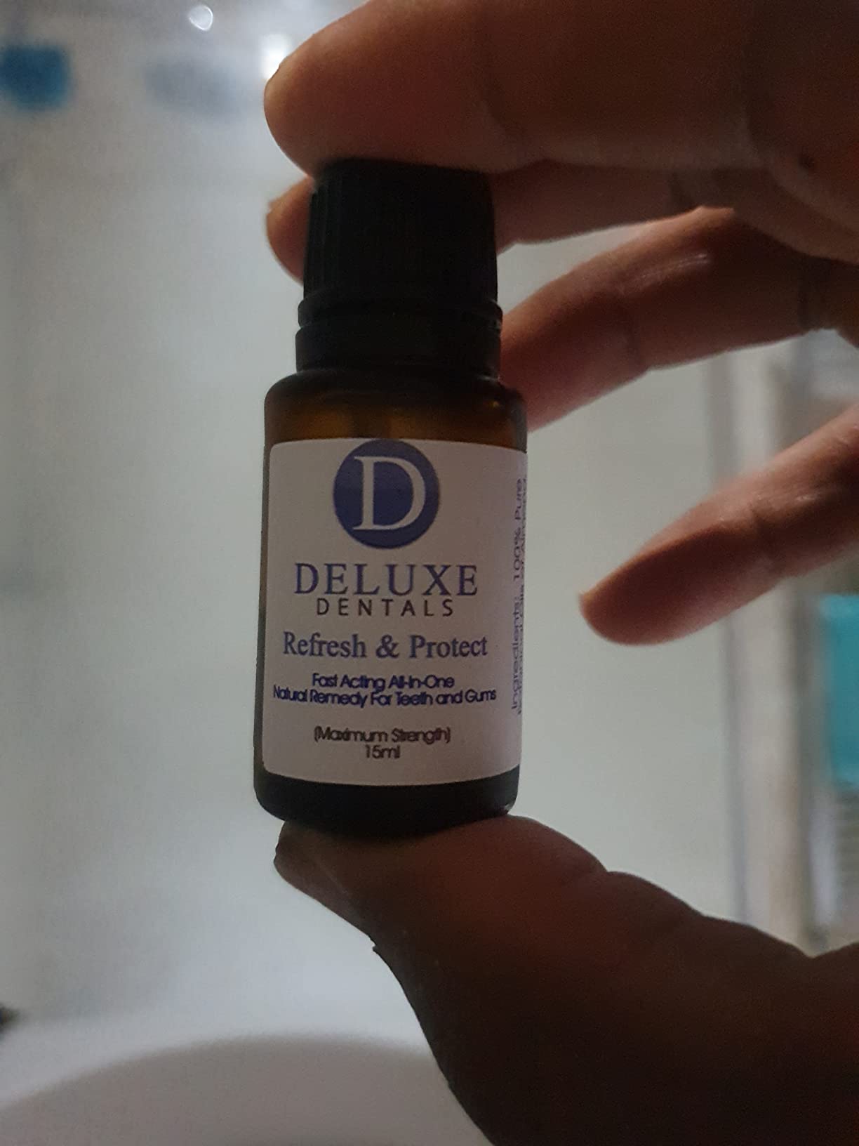 Close-up of the Refresh & Protect bottle held in front of a softly blurred background.