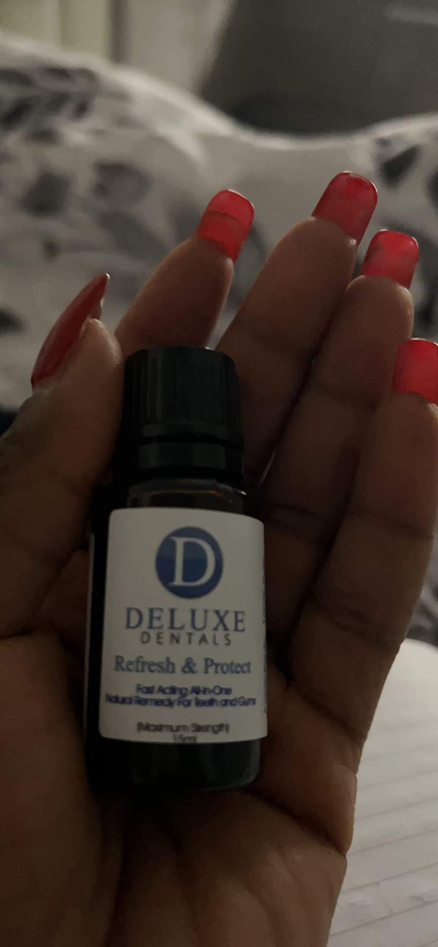 Close-up of a hand holding the Refresh & Protect bottle.