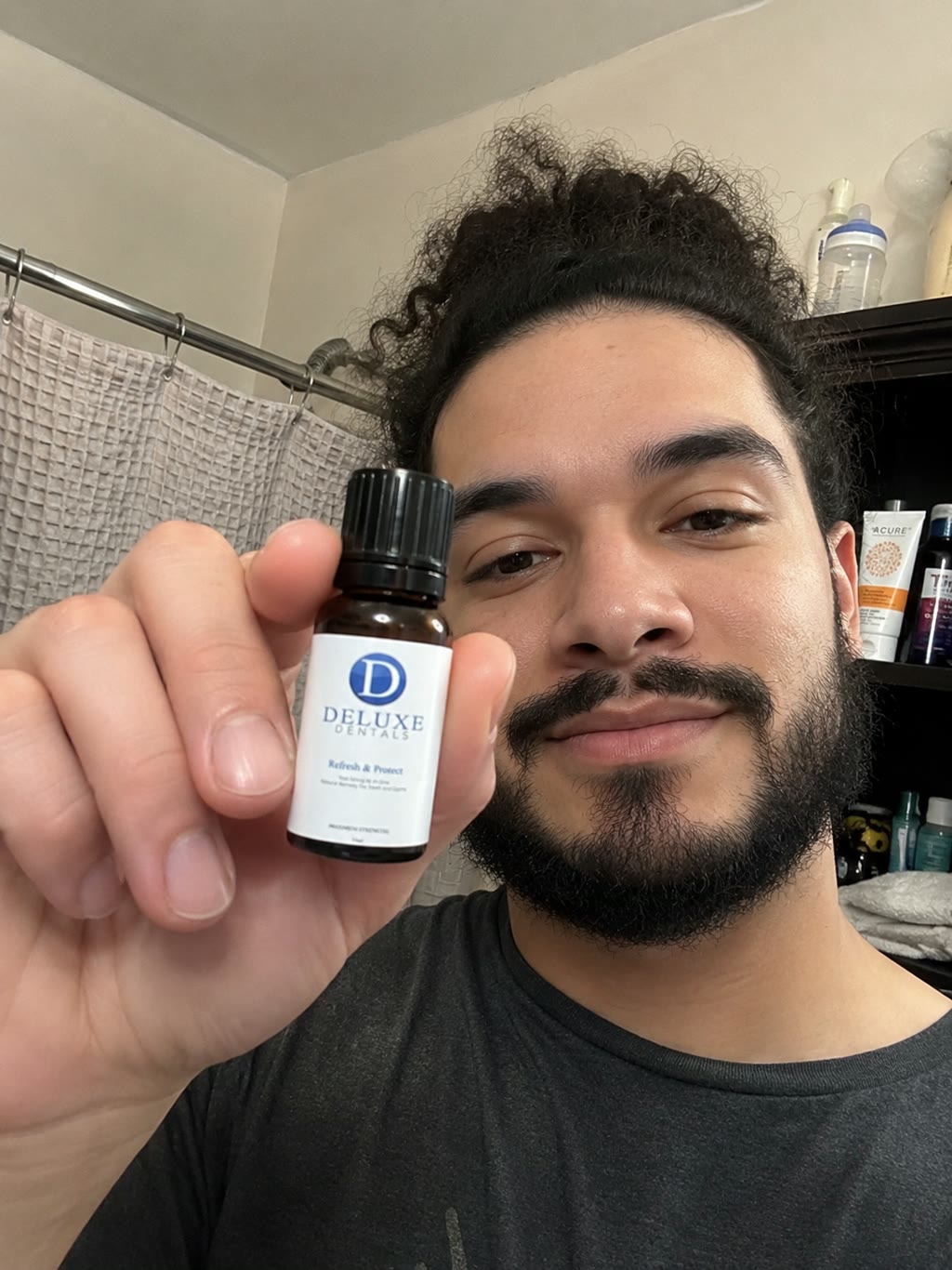 Customer holding the Refresh & Protect bottle up close in a bathroom.